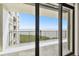 Balcony view of the water with railing and sliding glass doors and view to the apartment building at 1501 Gulf Blvd # 604, Clearwater Beach, FL 33767