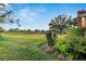 Spacious backyard with grassy area and mature trees at 1903 Country Club Ct, Plant City, FL 33566