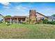 Back of house featuring a screened porch and brick exterior at 1903 Country Club Ct, Plant City, FL 33566