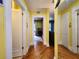 Long hallway with hardwood floors and doors leading to other rooms at 2515 York S St, Gulfport, FL 33707