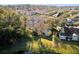 Aerial view of home with pond and lush trees at 3653 Kings Rd # 102, Palm Harbor, FL 34685