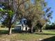 Spacious backyard with trees, chicken coop, and metal shed at 37210 Bermont Rd, Punta Gorda, FL 33982