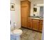 Bathroom with wood cabinets, granite countertop, and tile floor at 37210 Bermont Rd, Punta Gorda, FL 33982