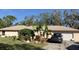 Single story home with a well-maintained lawn and attached garage at 37210 Bermont Rd, Punta Gorda, FL 33982
