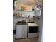 Laundry room with washer, dryer, and shelving for storage at 37210 Bermont Rd, Punta Gorda, FL 33982
