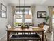 Bright dining room with farmhouse table and chandelier at 5035 Suncatcher Dr, Wesley Chapel, FL 33545