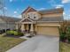 Two-story house with a front porch and attached garage at 5035 Suncatcher Dr, Wesley Chapel, FL 33545