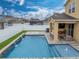 Stunning pool with water features and a patio seating area at 5035 Suncatcher Dr, Wesley Chapel, FL 33545