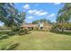 One-story home with stone accents and a well-manicured lawn at 902 Flatwood Ct, Brandon, FL 33511