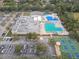 Aerial view of community center with pools, tennis and basketball courts at 970 Rolling Hills Dr, Palm Harbor, FL 34683