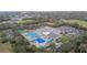 Community center with pools, tennis courts, playground, and parking at 970 Rolling Hills Dr, Palm Harbor, FL 34683