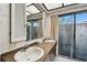 Bathroom with double vanity and access to backyard at 970 Rolling Hills Dr, Palm Harbor, FL 34683