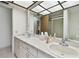 Double vanity bathroom with a shower and separate toilet at 970 Rolling Hills Dr, Palm Harbor, FL 34683