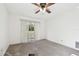 Bright bedroom with ceiling fan and sliding glass door leading to backyard at 970 Rolling Hills Dr, Palm Harbor, FL 34683