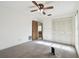 Spacious bedroom featuring a ceiling fan and ample closet space at 970 Rolling Hills Dr, Palm Harbor, FL 34683