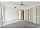 Bright bedroom with ceiling fan and access to hallway at 970 Rolling Hills Dr, Palm Harbor, FL 34683