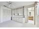Bedroom with built-in shelving, and access to bathroom at 970 Rolling Hills Dr, Palm Harbor, FL 34683