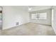 Bedroom with window, ceiling fan and access to patio at 970 Rolling Hills Dr, Palm Harbor, FL 34683