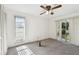 Bedroom with two windows, ceiling fan and carpet at 970 Rolling Hills Dr, Palm Harbor, FL 34683