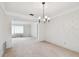 Spacious dining room with a chandelier and view to living room at 970 Rolling Hills Dr, Palm Harbor, FL 34683