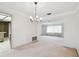 Dining room features a chandelier and view into living room at 970 Rolling Hills Dr, Palm Harbor, FL 34683