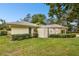 Single story home with landscaped lawn and gated entry at 970 Rolling Hills Dr, Palm Harbor, FL 34683