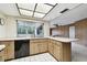 Kitchen with wood cabinets, black appliances, and island at 970 Rolling Hills Dr, Palm Harbor, FL 34683