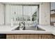 Kitchen sink with window overlooking the backyard at 970 Rolling Hills Dr, Palm Harbor, FL 34683