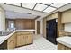 Kitchen with wood cabinets, black appliances, and tile floor at 970 Rolling Hills Dr, Palm Harbor, FL 34683