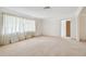 Bright living room with large windows and carpet flooring at 970 Rolling Hills Dr, Palm Harbor, FL 34683