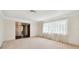 Bright living room featuring a large window and neutral decor at 970 Rolling Hills Dr, Palm Harbor, FL 34683