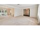 Open concept living and dining area with neutral carpeting at 970 Rolling Hills Dr, Palm Harbor, FL 34683