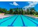 Community lap pool with plenty of deck space for lounging at 970 Rolling Hills Dr, Palm Harbor, FL 34683