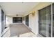 Sunlit screened porch featuring sliding glass doors and a ceiling fan at 970 Rolling Hills Dr, Palm Harbor, FL 34683