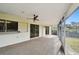 Bright screened porch with sliding glass doors and a ceiling fan at 970 Rolling Hills Dr, Palm Harbor, FL 34683