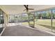 Spacious screened porch with ceiling fan overlooking backyard at 970 Rolling Hills Dr, Palm Harbor, FL 34683