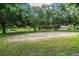 Outdoor volleyball court nestled among lush trees at 970 Rolling Hills Dr, Palm Harbor, FL 34683