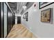 Modern hallway with hardwood floors and unique wall decor at 101 N 12Th St # 207, Tampa, FL 33602