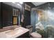 Bathroom with dark vanity, shower with playful curtain, and a mirror at 10212 Grant Creek Dr, Tampa, FL 33647