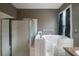 Bathroom featuring a walk-in shower and accessible bathtub at 10212 Grant Creek Dr, Tampa, FL 33647
