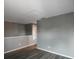 Empty bedroom with gray walls, wood-look floors, and a window with red curtains at 10212 Grant Creek Dr, Tampa, FL 33647