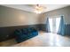 Spacious bonus room with a comfortable couch and double doors at 10212 Grant Creek Dr, Tampa, FL 33647