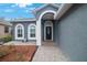 House entrance with arched entryway and black door at 10212 Grant Creek Dr, Tampa, FL 33647