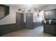 Hallway with gray walls, wood floors and access to kitchen and other rooms at 10212 Grant Creek Dr, Tampa, FL 33647