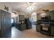 Modern kitchen with gray cabinets, black countertops, and stainless steel appliances at 10212 Grant Creek Dr, Tampa, FL 33647