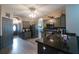 Modern kitchen with gray cabinets, black countertops, and stainless steel appliances at 10212 Grant Creek Dr, Tampa, FL 33647