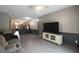 Living room with hardwood floors, gray couch, and white TV stand at 10212 Grant Creek Dr, Tampa, FL 33647