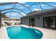 Inviting kidney-shaped pool with screened enclosure and patio at 10212 Grant Creek Dr, Tampa, FL 33647
