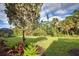 Landscaped backyard with lush greenery and spacious lawn at 11976 Blazing Star Dr, Venice, FL 34293