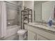 Clean bathroom with a shower/tub combo, toilet, and granite vanity at 11976 Blazing Star Dr, Venice, FL 34293